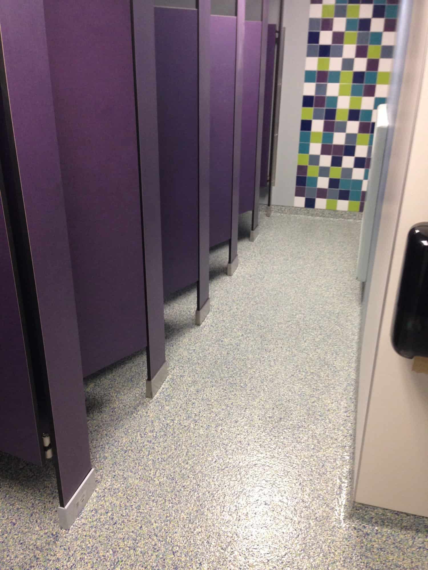 Decorative flake floor coating in a restroom