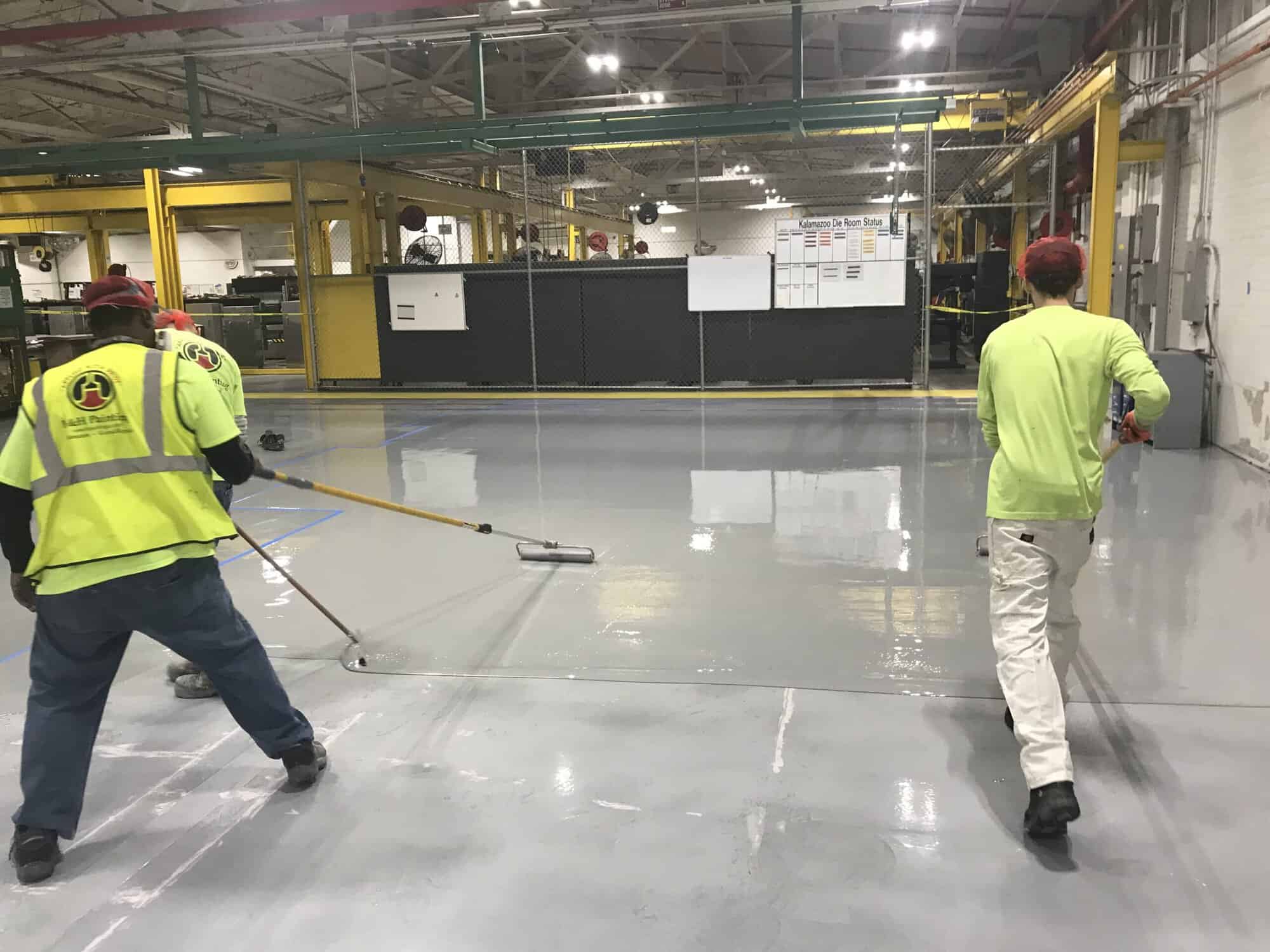 H&H crew applying floor coating in a manufacturing plant